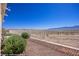 Backyard view featuring rock landscaping, shrubs, sturdy metal fence, and desert landscape at 700 Aztec Cir # 2E, Mesquite, NV 89027