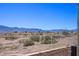 Desert landscape view from the backyard with a sturdy metal fence and rock landscaping at 700 Aztec Cir # 2E, Mesquite, NV 89027