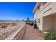 Backyard view featuring rock landscaping, sturdy metal fence, and the exterior of the home at 700 Aztec Cir # 2E, Mesquite, NV 89027