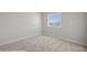 Bedroom with neutral walls, carpet and a window at 700 Aztec Cir # 2E, Mesquite, NV 89027