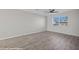 Bright bedroom featuring laminate flooring, a ceiling fan, and large view window at 700 Aztec Cir # 2E, Mesquite, NV 89027