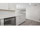 Lovely kitchen with stainless steel dishwasher, marble countertops, and white cabinetry at 700 Aztec Cir # 2E, Mesquite, NV 89027