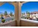 Balcony view of community featuring desert landscaping, trees, parking, and surrounding buildings at 700 Aztec Cir # 2E, Mesquite, NV 89027