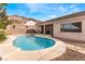 Private backyard features a sparkling pool and spa combo with mountain views in the background at 7076 Oakleigh Dr, Las Vegas, NV 89110