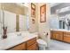 This bathroom offers oak cabinets and a white sink with views to another bathroom at 7076 Oakleigh Dr, Las Vegas, NV 89110