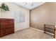 This bedroom features a dark wood dresser, carpeted floors, and a ceiling fan at 7076 Oakleigh Dr, Las Vegas, NV 89110