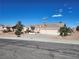 Inviting single-story home with three-car garage and desert landscaping on a sunny day at 7076 Oakleigh Dr, Las Vegas, NV 89110