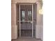 Close-up of an ornate security gate with a decorative metal design on a stucco home at 7076 Oakleigh Dr, Las Vegas, NV 89110