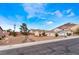 Attractive single-story home with a three-car garage, desert landscaping, and portable storage on the driveway at 7076 Oakleigh Dr, Las Vegas, NV 89110