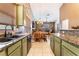 Kitchen with granite countertops, wood cabinets, and an open view to the dining and living areas at 7076 Oakleigh Dr, Las Vegas, NV 89110