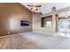 Spacious living room featuring carpet, high ceilings, a ceiling fan, and a mounted television at 7076 Oakleigh Dr, Las Vegas, NV 89110