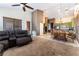 Spacious living room and dining area, featuring a leather sectional sofa and kitchen access at 7076 Oakleigh Dr, Las Vegas, NV 89110