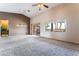 Open living room featuring plush carpet, neutral tones, high ceilings, and a sliding glass door at 7076 Oakleigh Dr, Las Vegas, NV 89110