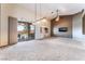 Bright living room with high ceilings, neutral carpet, large sliding glass doors, and a ceiling fan at 7076 Oakleigh Dr, Las Vegas, NV 89110