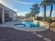 Inviting backyard oasis features a sparkling pool and spa, palm trees, and desert landscaping at 7076 Oakleigh Dr, Las Vegas, NV 89110