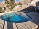 Inviting backyard pool with a beautiful view of desert landscaping and hills in the background at 7076 Oakleigh Dr, Las Vegas, NV 89110