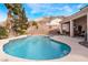 Inviting pool and spa surrounded by ample patio space with mountain views in the background at 7076 Oakleigh Dr, Las Vegas, NV 89110