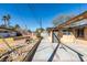 Backyard featuring a concrete patio and walkway leading to a detached structure with a yard requiring maintenance at 709 N 22Nd St, Las Vegas, NV 89101