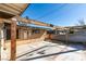 An expansive backyard featuring a concrete patio, a wooden pergola, and an stucco exterior at 709 N 22Nd St, Las Vegas, NV 89101