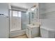 Cozy bathroom with a shower and tub combo, single sink vanity and tiled walls at 709 N 22Nd St, Las Vegas, NV 89101