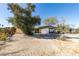 Single-story home featuring a covered carport and a spacious front yard with mature trees at 709 N 22Nd St, Las Vegas, NV 89101