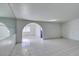 Bright living room with tile flooring and an arched entryway to another room at 709 N 22Nd St, Las Vegas, NV 89101