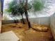 The backyard featuring trees, rock landscaping, and a brick patio at 7949 Long Beach St, Las Vegas, NV 89139