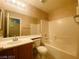 Bathroom featuring oak vanity, mirror and tub shower combination at 7949 Long Beach St, Las Vegas, NV 89139