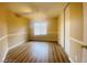 Bright bedroom featuring vinyl plank flooring, a ceiling fan and a window at 7949 Long Beach St, Las Vegas, NV 89139