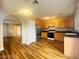 Spacious kitchen featuring stainless steel refrigerator, oak cabinets and modern flooring at 7949 Long Beach St, Las Vegas, NV 89139