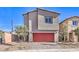 Modern two-story home showcasing a red garage door and low-maintenance landscaping at 795 Ruby Sedona Ave # Lot 128, North Las Vegas, NV 89081