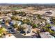 A high angle view of a neighborhood featuring desert landscaping, swimming pools, and tile roofs at 8875 Steven Chase Ct, Las Vegas, NV 89149