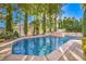 A private backyard features a pristine pool and spa surrounded by lush landscaping and a waterfall feature at 8875 Steven Chase Ct, Las Vegas, NV 89149