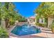 A backyard featuring a pool and spa, surrounded by mature landscaping and hardscape, offers a private oasis at 8875 Steven Chase Ct, Las Vegas, NV 89149