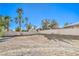 Large vacant backyard ready for landscaping, with fencing, and a desert rock ground cover at 8875 Steven Chase Ct, Las Vegas, NV 89149