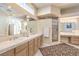 This bathroom has a double vanity, glass shower, and ample lighting at 8875 Steven Chase Ct, Las Vegas, NV 89149