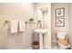 Charming powder room featuring pedestal sink and decorative accents at 8875 Steven Chase Ct, Las Vegas, NV 89149