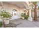 Inviting front porch with decorative columns and potted plants flanking the front doorway at 8875 Steven Chase Ct, Las Vegas, NV 89149