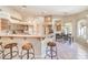 Spacious kitchen featuring bar-style seating, stainless steel appliances, and tile flooring at 8875 Steven Chase Ct, Las Vegas, NV 89149