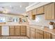 Well-lit kitchen featuring light-colored cabinets and tiled backsplash at 8875 Steven Chase Ct, Las Vegas, NV 89149