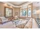 Inviting living room featuring neutral tones, large windows, and stylish furnishings at 8875 Steven Chase Ct, Las Vegas, NV 89149