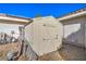 Backyard featuring a storage shed, surrounded by rock and adjacent to a block wall at 8875 Steven Chase Ct, Las Vegas, NV 89149