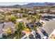 Charming desert home featuring mature palm trees, a tiled roof, and mountain views at 8875 Steven Chase Ct, Las Vegas, NV 89149