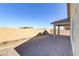 Paved backyard patio area, showcasing stucco walls and a covered patio at 92 Starlight Sonata Ave, Henderson, NV 89015