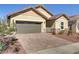 Charming single-story home with desert landscaping, a brick-paved driveway, and a two-car garage at 92 Starlight Sonata Ave, Henderson, NV 89015