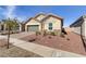 Charming single-story home with desert landscaping, a brick-paved driveway, and a two-car garage at 92 Starlight Sonata Ave, Henderson, NV 89015