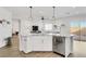 Kitchen island with granite countertops, stainless steel dishwasher, and breakfast bar seating at 92 Starlight Sonata Ave, Henderson, NV 89015