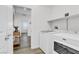 Functional laundry room with a modern washer and dryer and built-in shelf at 92 Starlight Sonata Ave, Henderson, NV 89015