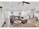 Open-concept living room with modern decor, wood floors, and a seamless flow into the kitchen at 92 Starlight Sonata Ave, Henderson, NV 89015