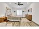 Bright main bedroom with a ceiling fan, wood-style flooring, and lots of natural light at 92 Starlight Sonata Ave, Henderson, NV 89015